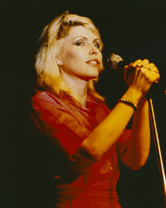 Deborah Harry in red outfit singing into mike on stage 16×20 Canvas Giclee