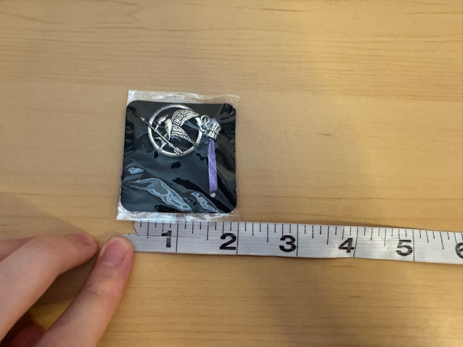 Mockingjay pendant from The Hunger Games franchise. New