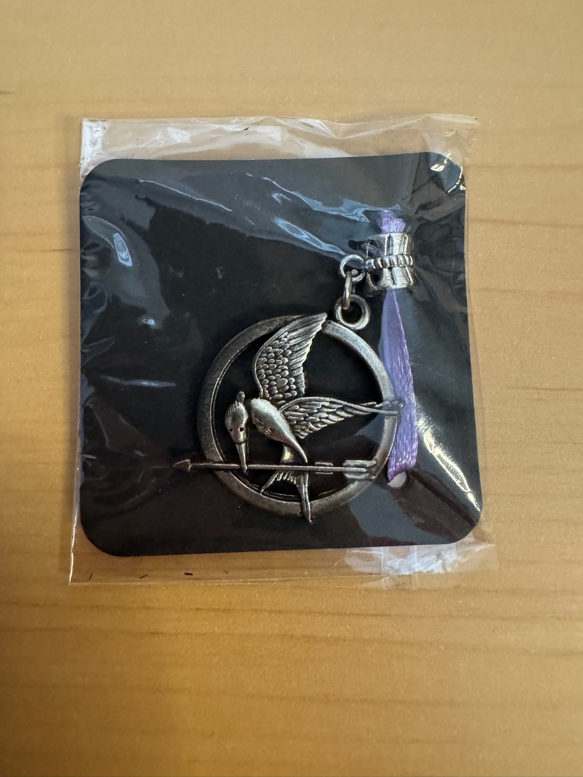 Mockingjay pendant from The Hunger Games franchise. New