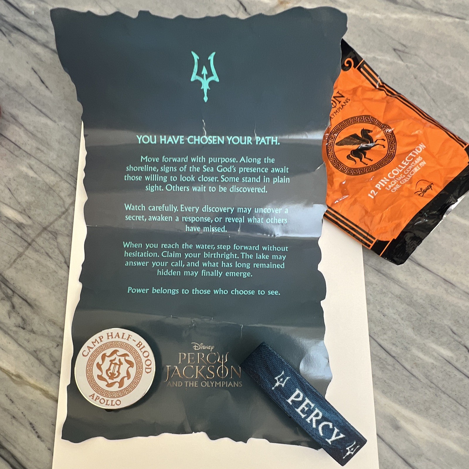 Disney Percy Jackson Olympians Camp Half-Blood Apollo Pin, bracelet, paper