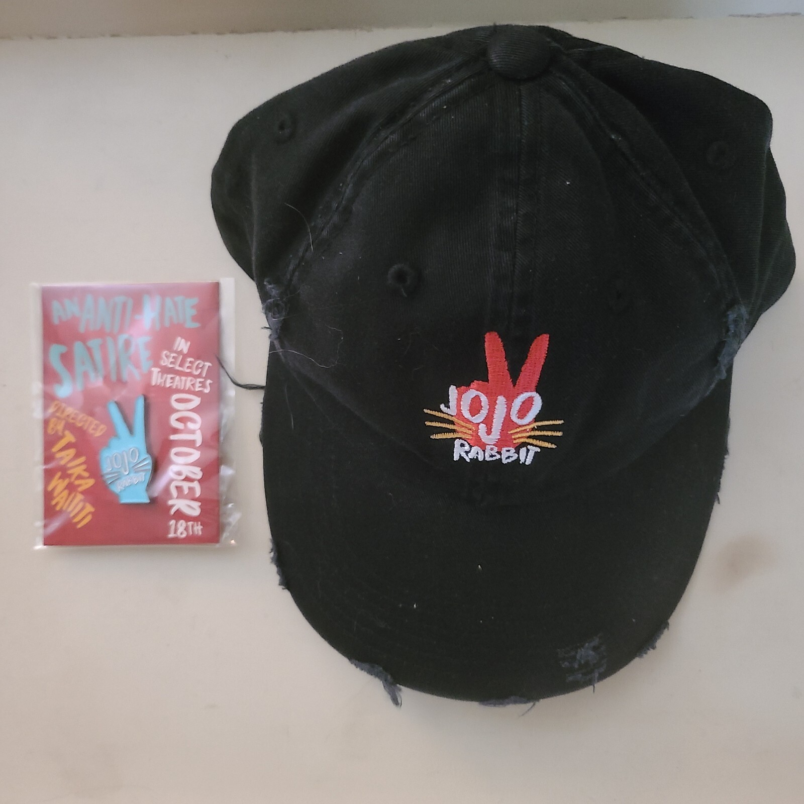 JO JO RABBIT ~ Lot of 2 ~ BLACK BALL CAP + JOJO RABBIT LAPEL PIN ~ NEW